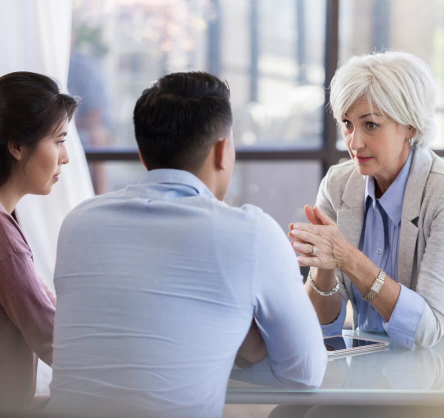 woman a care manager  meeting with a married man and woman to discuss best home health care